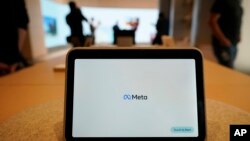 FILE - A Meta Portal Go is displayed at a Meta Store in Burlingame, Calif., May 4, 2022. There has been a marked rise in sextortion cases in recent years, fueled in part by a loosely organized group called the Yahoo Boys, operating mainly out of Nigeria, Meta said. 