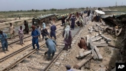 Workers repair a railway track at the site of Sunday's train derailment, near Nawabshah, a district of Pakistan's southern Sindh province, Aug. 7, 2023. 
