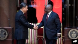 Chinese President Xi Jinping, left, shakes hand with South Africa's President Cyril Ramaphosa after their joint media briefing at Union Building in Pretoria, South Africa, Aug. 22, 2023.