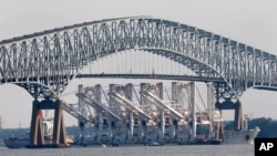 FILE - The vessel Zhen Hua 13, carrying four giant shipping cranes for delivery and installation at the Port of Baltimore, passes under the Francis Scott Key Bridge in Baltimore, June 20, 2012.