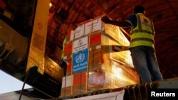 FILE - Aid supplies from World Health Organization (WHO) and UAE-AID are loaded into a plane for Port Sudan, at the Abu Dhabi International Airport, Abu Dhabi, United Arab Emirates, May 5, 2023. 