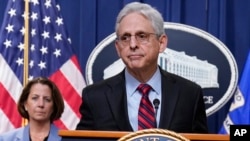 FILE — Attorney General Merrick Garland speaks at the Department of Justice in Washington, April 13, 2023, as Deputy Attorney General Lisa Monaco, left, stands by.