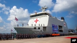 FILE - Military personnel stand near Indonesian Navy hospital ship KRI dr. Radioman Wedyodiningrat during the opening ceremony of the military non-combat exercise called ASEAN Solidarity Exercise at Batu Ampar Port on Batam island, Sept. 19, 2023.