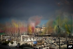 Fireworks go off as the Belem, the three-masted sailing ship which is carrying the Olympic flame, enters the Old Port in Marseille, southern France, May 8, 2024.