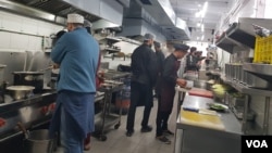 Ahmad Kamal Zarief, co-owner of Lhasa Restaurant, instructs his chef on May 25, 2023, in Srinagar, Jammu and Kashmir, India. (Bilal Hussain/VOA)