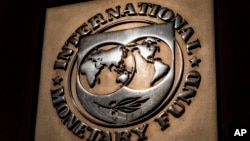 FILE - The logo of the International Monetary Fund is visible on its building in Washington, April 5, 2021. 