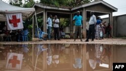 Family members and friends await news at the morgue of Malindi Sub-County Hospital in Malindi, Kenya, on April 26, 2023, of loved ones in an area where 90 bodies have been exhumed so far of people who had starved to death.