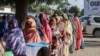 Women queue to cast their votes during the constitutional referendum at a polling station in N'Djamena, Dec. 17, 2023. The vote seen as a key step towards elections and the return of civilian rule promised, but postponed, by the ruling military junta.