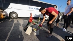 Mourners lay roses at the site where three Palestinians were killed by Israeli forces near the Jenin camp, north of the occupied West Bank, Aug. 6, 2023. 