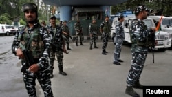 FILE - Indian security force personnel stand guard near the venue of India's Independence Day celebrations in Srinagar, Aug. 15, 2022.