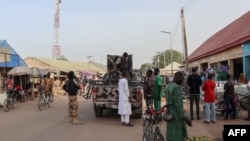 FILE - Nigerian security forces are seen in a street in Chibok, March 31, 2024. Almost 100 of the 276 girls seized from their school in Chibok by Boko Haram fighters in 2014 are still thought to be in captivity. 