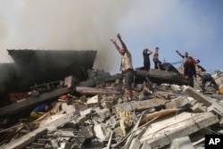 Palestinians look for survivors of the Israeli bombardment of the Gaza Strip in Rafah, Oct. 23, 2023.