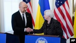 Treasury Secretary Janet Yellen and Ukraine's Prime Minister Denys Shmyhal shake hands after speaking at the Treasury Department in Washington, April 13, 2023.