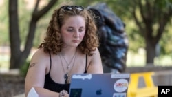 Stella Gage, 19, a sophomore psychology and sociology major at Wichita State University, studies on the campus in Wichita, Kan., Sept. 26, 2023. 