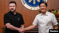 Ukrainian President Volodymyr Zelenskyy shakes hands with Philippine President Ferdinand "Bongbong" Marcos Jr. at Malacanang Palace in Manila, June 3, 2024.