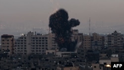 Smoke rises above buildings in Gaza City as Israel launched air strikes on the Palestinian enclave early on Feb. 23, 2023. 
