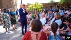 President Joe Biden speaks to supporters as first lady Jill Biden, second from left, listens, at a campaign rally in Harrisburg, Pennsylvania, July 7, 2024.