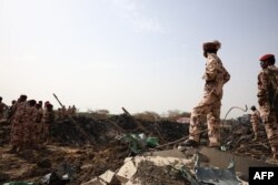 Members of the Chadian security forces stand at the scene of the fire at a ammunition depot in N'Djamena on June 19, 2024.
