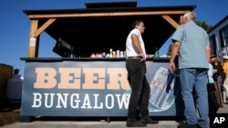 Republican presidential candidate Ryan Binkley, left, talks with Ron Fodor of Slippery Rock, Pennsylvania, at the Iowa State Fair on Aug. 15, 2023, in Des Moines, Iowa.