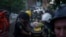 Rescue workers and police officers carry an injured person on a stretcher to an ambulance from a building destroyed by a Russian airstrike in Kharkiv, Ukraine, June 10, 2024. 