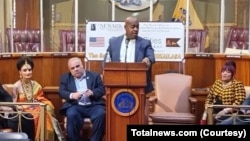FILE- Signing ceremony featuring Newark’s mayor (center) and a supposed representative of the fake country of Kailasa (second from the left), Newark, New Jersey, Jan. 12, 2023.