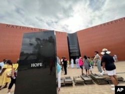 People visit the National Monument to Freedom in Montgomery, Alabama, June 19, 2024.