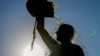 FILE - A man rinses with fresh water on a sweltering hot day, at the Ramlet al-Baida public beach in Beirut, Lebanon, July 16, 2024. 