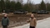 Poland's President Andrzej Duda, right, and Defense Minister Mariusz Blaszczak speak at a press conference at a military base and test range where Ukrainian troops are trained how to operate Leopard 2 tanks, in Swietoszow, Poland, Feb. 13, 2023.