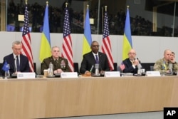 NATO Secretary-General Jens Stoltenberg, Chairman of the U.S. Joint Chiefs of Staff General Mike Milley, U.S. Secretary of Defense Lloyd Austin, Ukraine's Defense Minister Oleksii Reznikov and Ukraine's Lieutenant General Yevhen Moisiuk, are seen during the North Atlantic Council round table meeting in Brussels, Feb. 14, 2023.