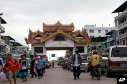 FILE - Vehicles are in line for custom clearance before crossing a border bridge to Thailand in Myawaddy, Karen State, Myanmar, close to the border with Thailand, May 12, 2012.