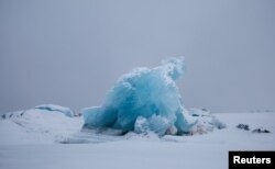 Blue ice is seen at frozen Kongsfjord near Ny-Aalesund, Svalbard, April 8, 2023.