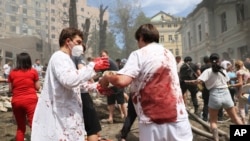 Rescuers, medical staff and volunteers clean up the rubble and search victims after Russian missile strikes on Okhmatdyt Children's Hospital in Kyiv, Ukraine, July 8, 2024.
