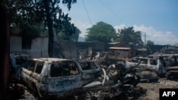 FILE - The charred remains of vehicles that were burned near a garage are seen in Port-au-Prince, Haiti, on March 25, 2024. The UN described the situation in the chaos-wracked country as 'cataclysmic.'