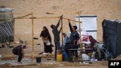 Palestinian pack their belongings as they prepare to flee Rafah in the southern Gaza Strip on May 13, 2024, amid the ongoing conflict between Israel and the Hamas militant group.