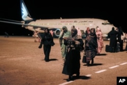 Sudanese, who had been stranded in Jeddah, Saudi Arabia, arrive at Port Sudan airport, Thursday, May 11, 2023.
