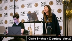 Kelly Phil (standing) and teammate Rafael Pierry from the University of Michigan debate during the final round of the National Debate Tournament, Monday, April 4 in Chantilly, Virginia. (Photo Courtesy of Claire Brickson)