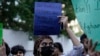 A social group, Aurat March, hold signs during a demonstration against Pakistani government, in Karachi, Oct. 29, 2023. Pakistan has recently announced plans to deport all migrants who are in the country illegally, including 1.7 million Afghans.