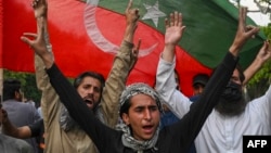 Pakistan Tehreek-e-Insaf (PTI) party activists and supporters of Pakistan's former Prime Minister Imran Khan celebrate after Supreme Court declared Khan's arrest "invalid", in Lahore, Pakistan, May 11, 2023.