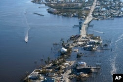 The bridge leading from Fort Myers to Pine Island, Fla., is heavily damaged in the aftermath of Hurricane Ian, Oct. 1, 2022. (AP Photo/Gerald Herbert, File)