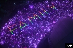 Supporters form the word 'Family' during the annual Pink Dot event in a public show of support for the LGBTQ community at Hong Lim Park in Singapore, June 24, 2023.