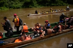 Migrants heading north arrive via boats at Lajas Blancas, Panama, June 28, 2024, after walking across the Darien Gap from Colombia.