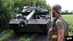 FILE - Ukrainian marines check their French-made AMX-10 RC armored fighting vehicle at a position in the Donetsk region on July 10, 2023.