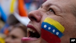 A supporter of opposition presidential candidate Edmundo Gonzalez cheers as thousands await his arrival at a campaign rally in Barinas, Venezuela, July 6, 2024. 