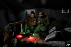 Ukrainian Border Guard soldiers test a drone prior a military exercise in central Ukraine, May 1, 2023.