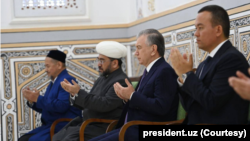 Uzbek leader Shavkat Mirziyoyev praying with country's Grand Mufti Nuriddin Kholiknazarov and other officials at Al-Hakim At-Termizi Mausoleum in Surkhandarya, southern Uzbekistan, March 13, 2023. (president.uz) 