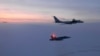 FILE - In this March 9, 2020, photo released by the North American Aerospace Defense Command (NORAD), a Russian Tu-142 maritime reconnaissance aircraft, top, is intercepted near Alaska. NORAD said it tracked two Russian and two Chinese aircraft off the coast of Alaska.