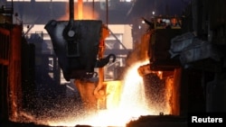 FILE - Workers monitor the nickel melting process at a nickel smelter of PT Vale Tbk in Sorowako, South Sulawesi province, Indonesia, March 30, 2023.