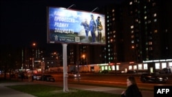 A billboard promoting contract army service and reading "Our job, defending the homeland" sits on the outskirts of Moscow on April 24, 2023. 