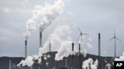 FILE - The industrial backdrop of a BP refinery and a Uniper coal-fired power plant is seen in Gelsenkirchen, Germany, March 6, 2023.