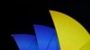FILE - The sails of the Sydney Opera House get illuminated with the colors of the Ukrainian Flag to mark one year since Russia's invasion of Ukraine began, in Sydney, Feb. 24, 2023. More than 11,000 Ukrainians have come to Australia since Russia invaded in Feb. 2022.